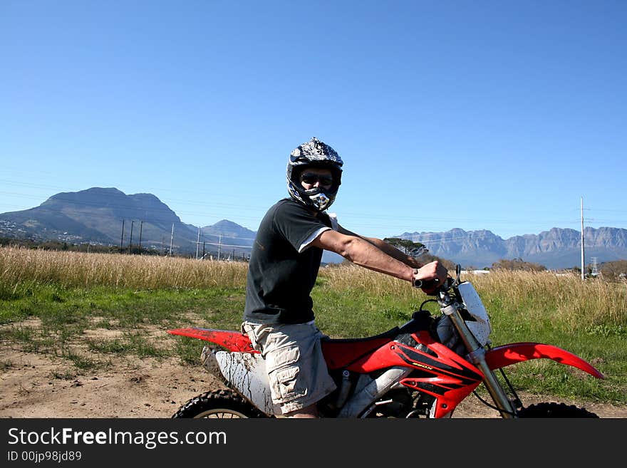 Young biker on his bike on an off road course