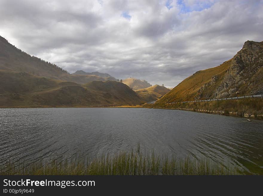 Mountain lake in the Swiss Alpes in cloudy autumn day. Mountain lake in the Swiss Alpes in cloudy autumn day