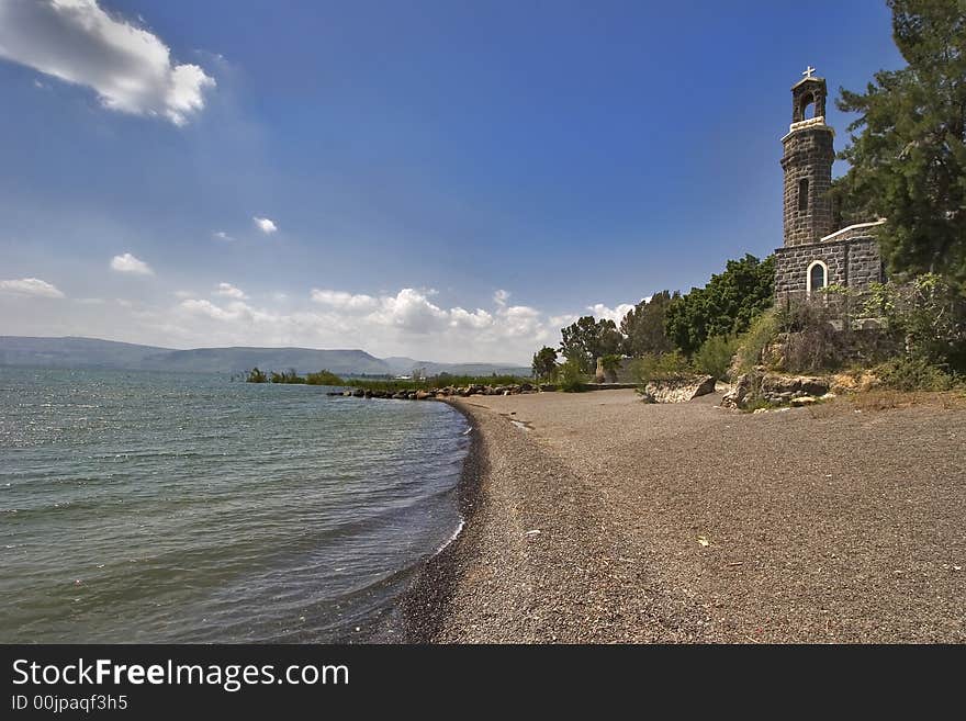 Ancient church and trees at coast of lake of Tiberias in the spring. Ancient church and trees at coast of lake of Tiberias in the spring