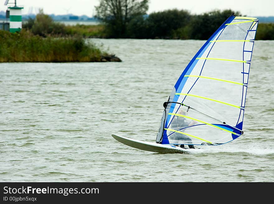 Windsurfer going fast on a lake