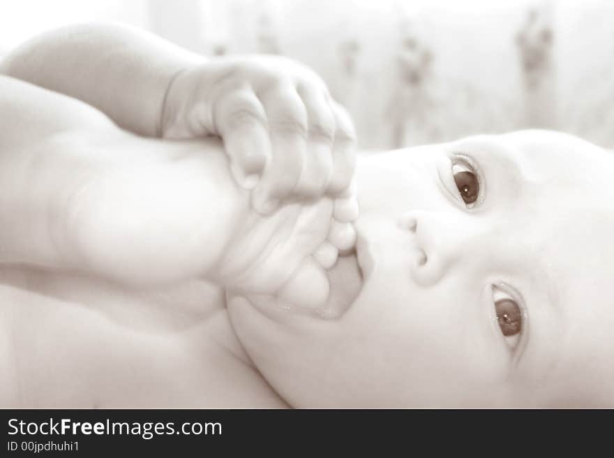 Close up of a baby with his foot in mouth