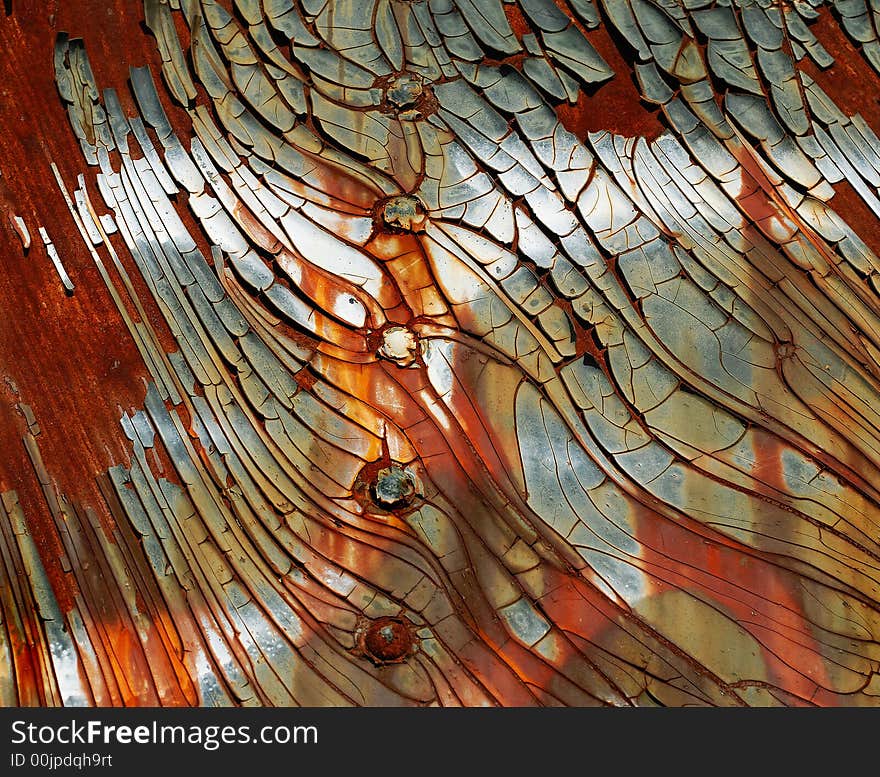 Paint chipping on the side of an old train wagon with rust showing through. Paint chipping on the side of an old train wagon with rust showing through