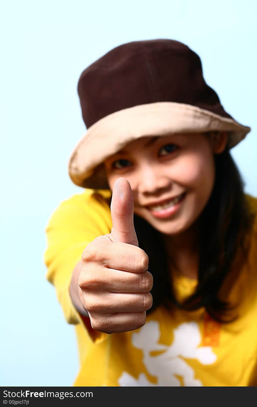 Young asian woman giving the thumbs up sign. Young asian woman giving the thumbs up sign