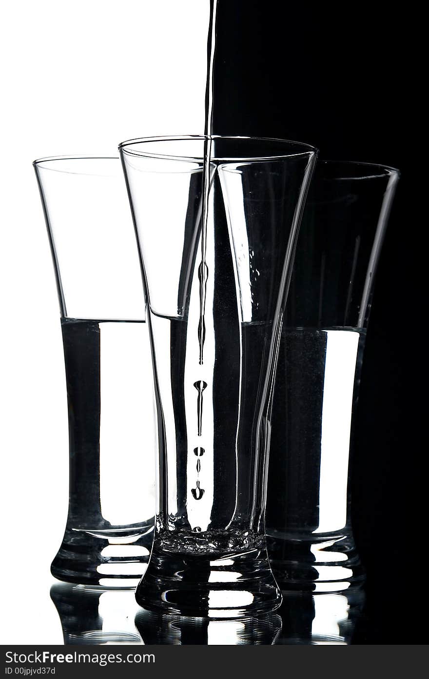 Still life with glasses on the white and black background;