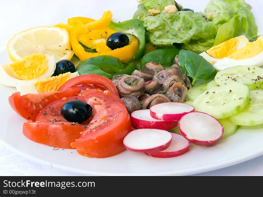 Delicatessen anchovy mixed - vegetable salad with boilrd eggs.