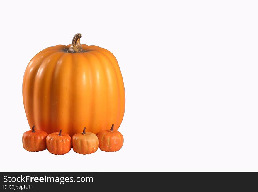 Large pumpkin with three small pumpkins in front of it. Large pumpkin with three small pumpkins in front of it