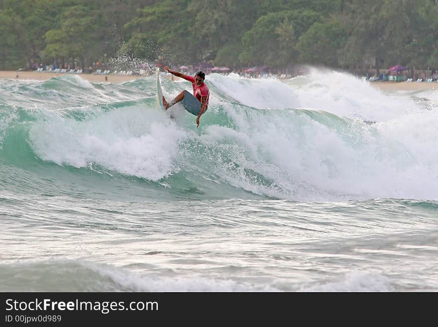 A local surfer hits the lip of a wave on a beach in Phuket, Thailand. A local surfer hits the lip of a wave on a beach in Phuket, Thailand