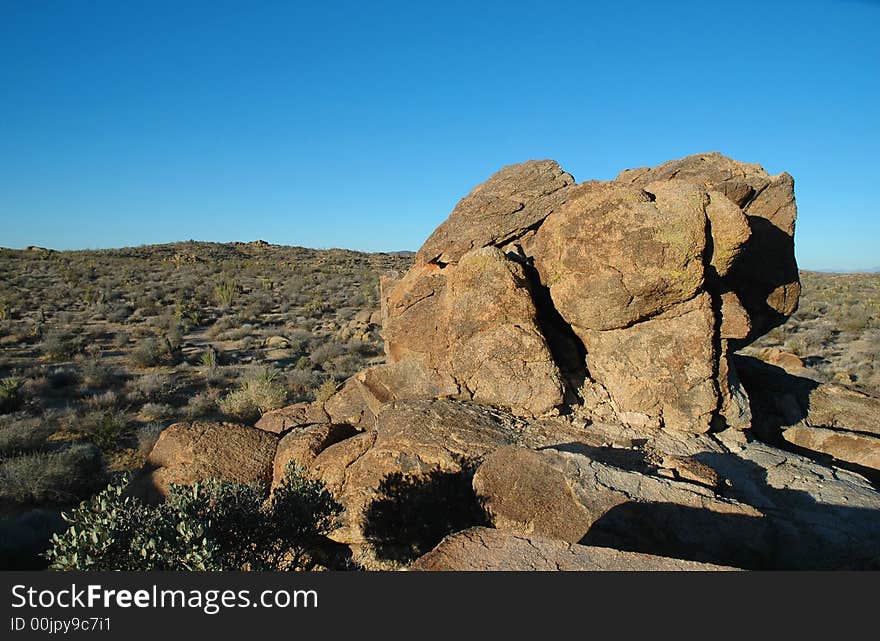 A landscape image from Joshua Tree National Park featuring large boulders and desert.