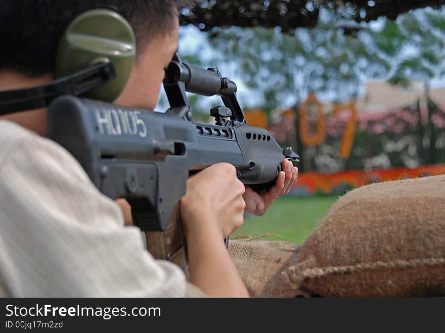 People Firing Machine Gun