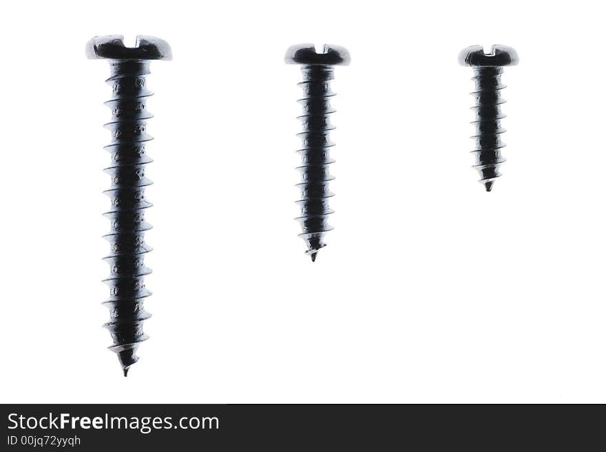 Macro Close-Up Of Three Spiral Metal Screws On A White Background