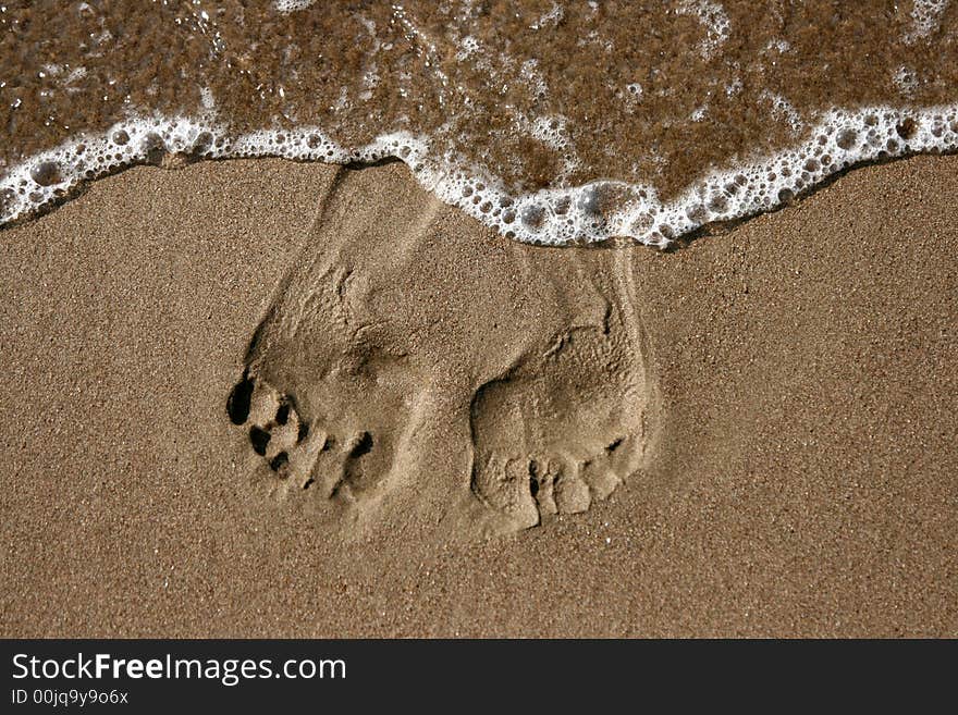 Traces of legs on sand, on seacoast