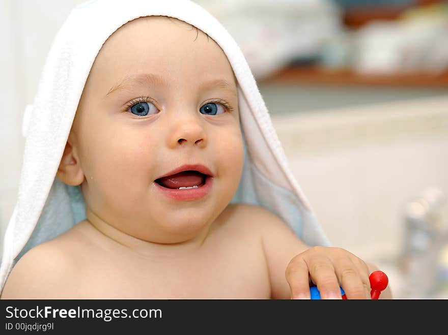 Baby under white towel