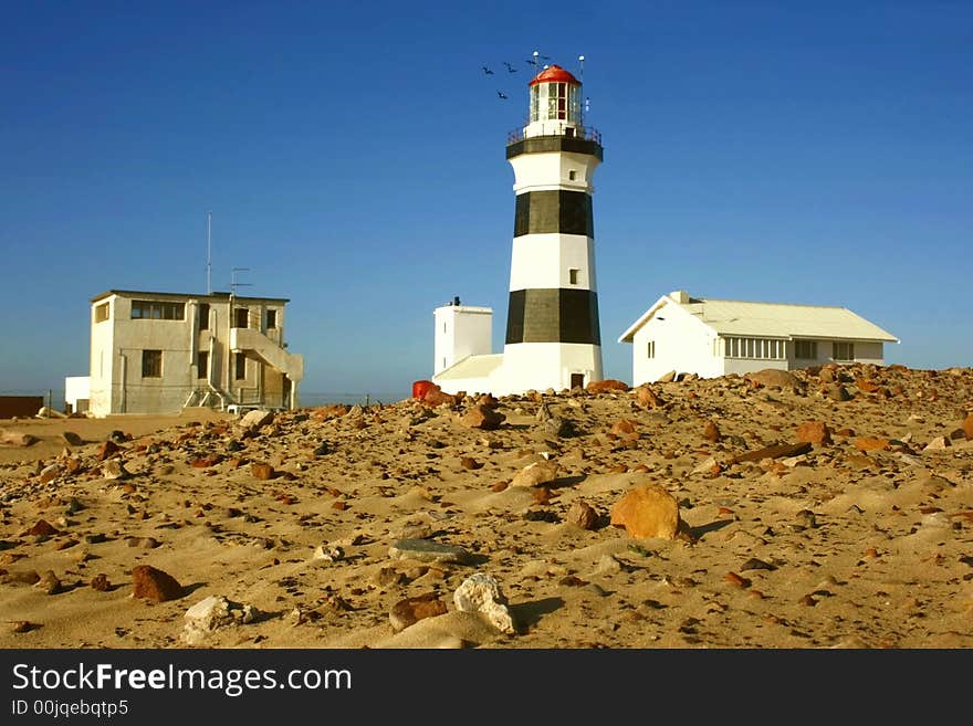 Lighthouse with some birds flying arround it. Lighthouse with some birds flying arround it