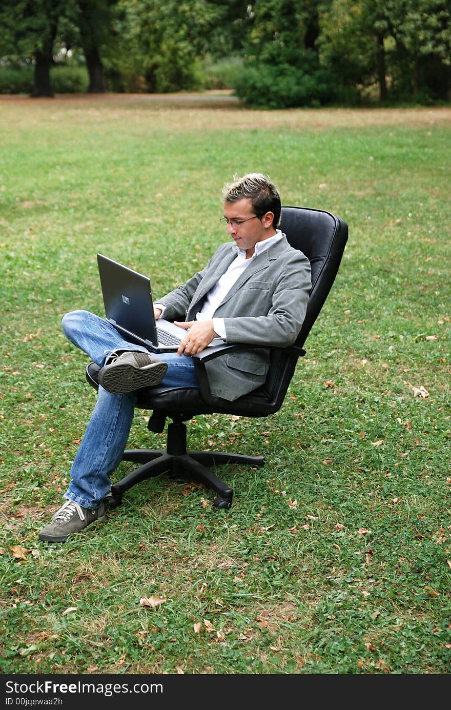 Man with a laptop working in a field