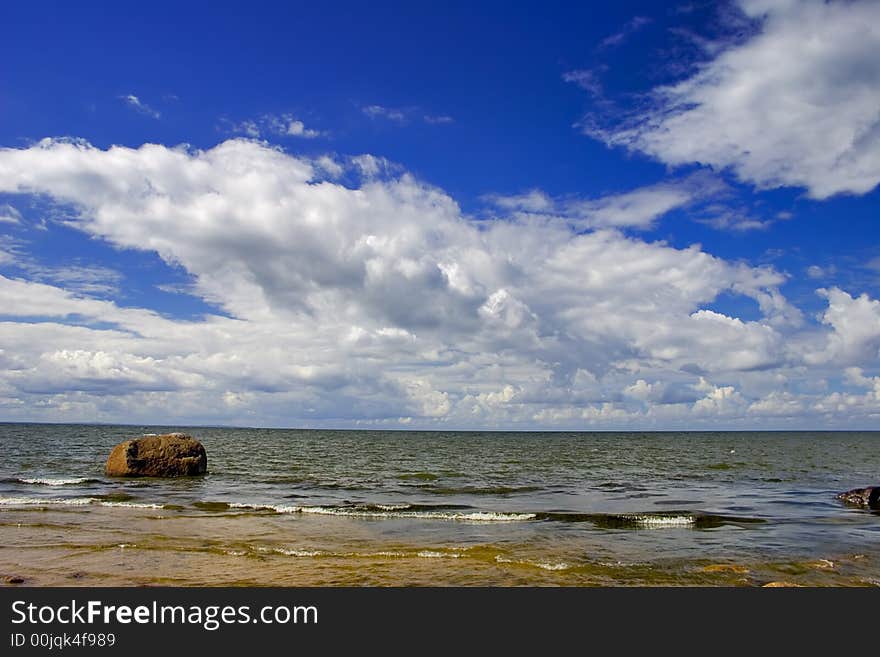 Landscape with blue sky, clouds, stones and sea. Landscape with blue sky, clouds, stones and sea