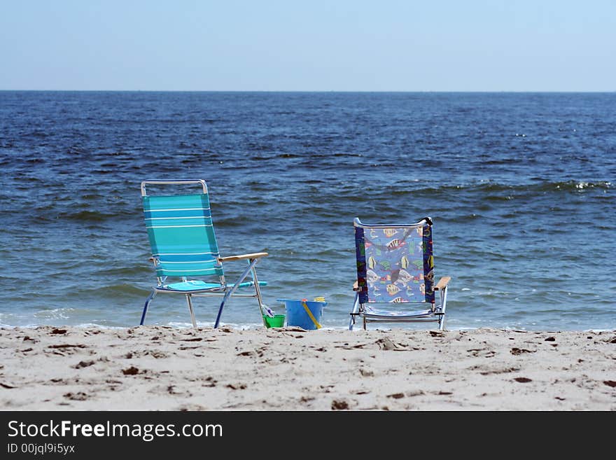 Beach Chairs near the ocean with bucket