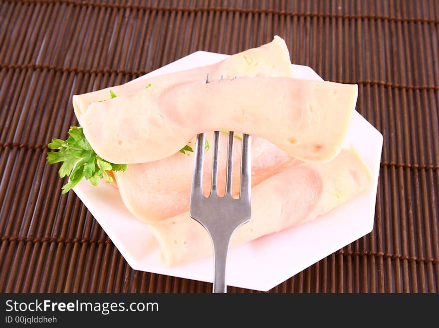 Ham slices on fork with top slice folded