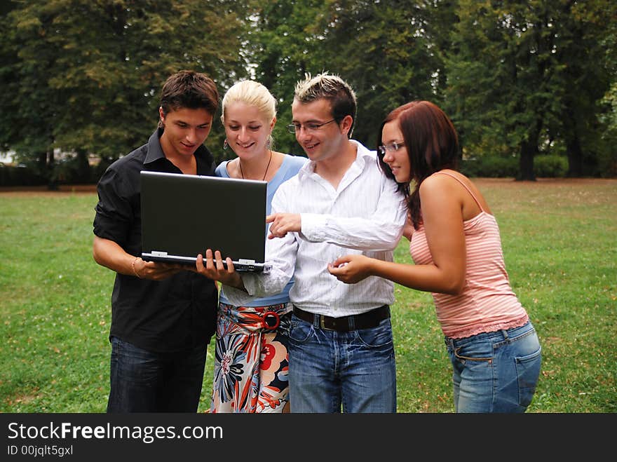 Group of people smiling and working in the field on the laptop