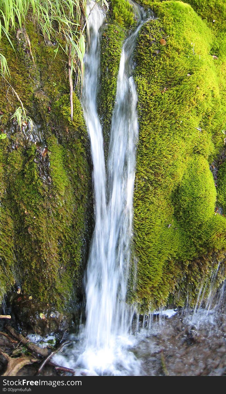 Water fall between stones coverd with moss in a national park. Water fall between stones coverd with moss in a national park