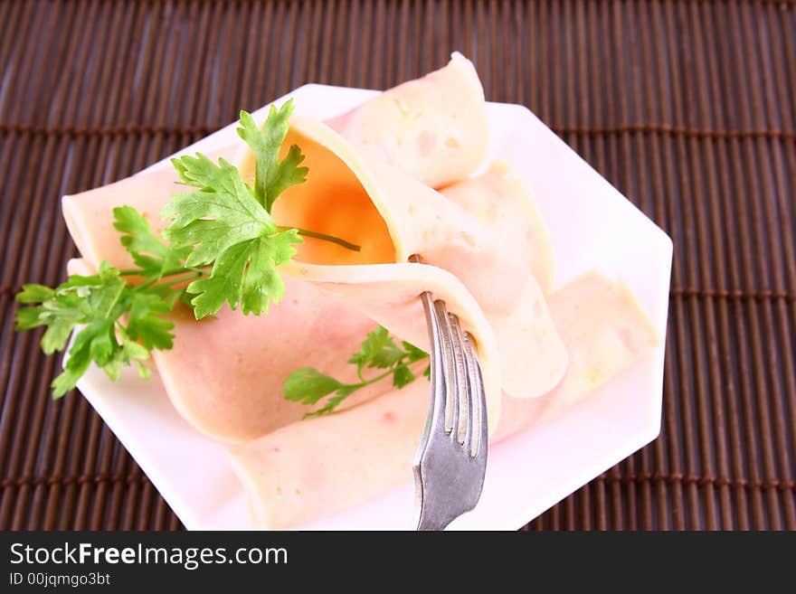 Ham slices on fork with top slice folded