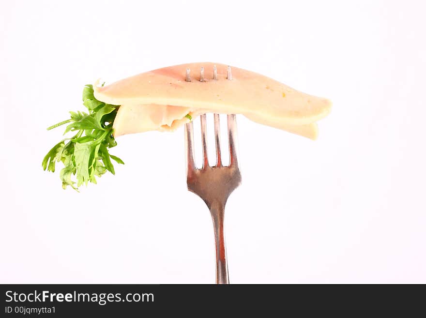 Ham slices on fork  with top slice folded