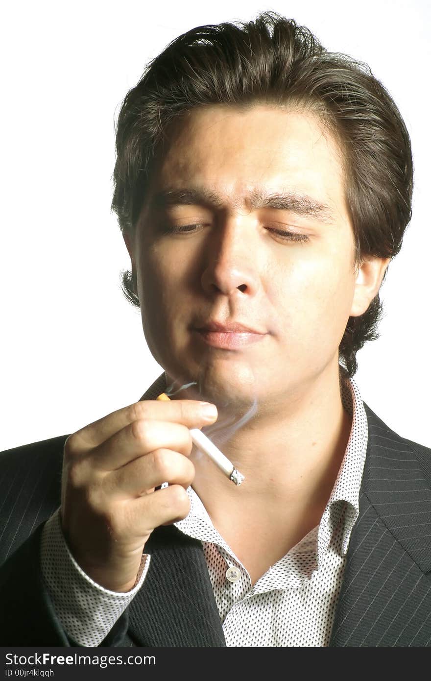 Young businessman sees his cigarette. Studio shot, isolated over white. Young businessman sees his cigarette. Studio shot, isolated over white.