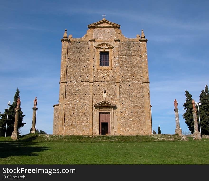 The church of Saint Justus in Volterra, Tuscany, which sits isolated upon a green grassy hill. The church of Saint Justus in Volterra, Tuscany, which sits isolated upon a green grassy hill.