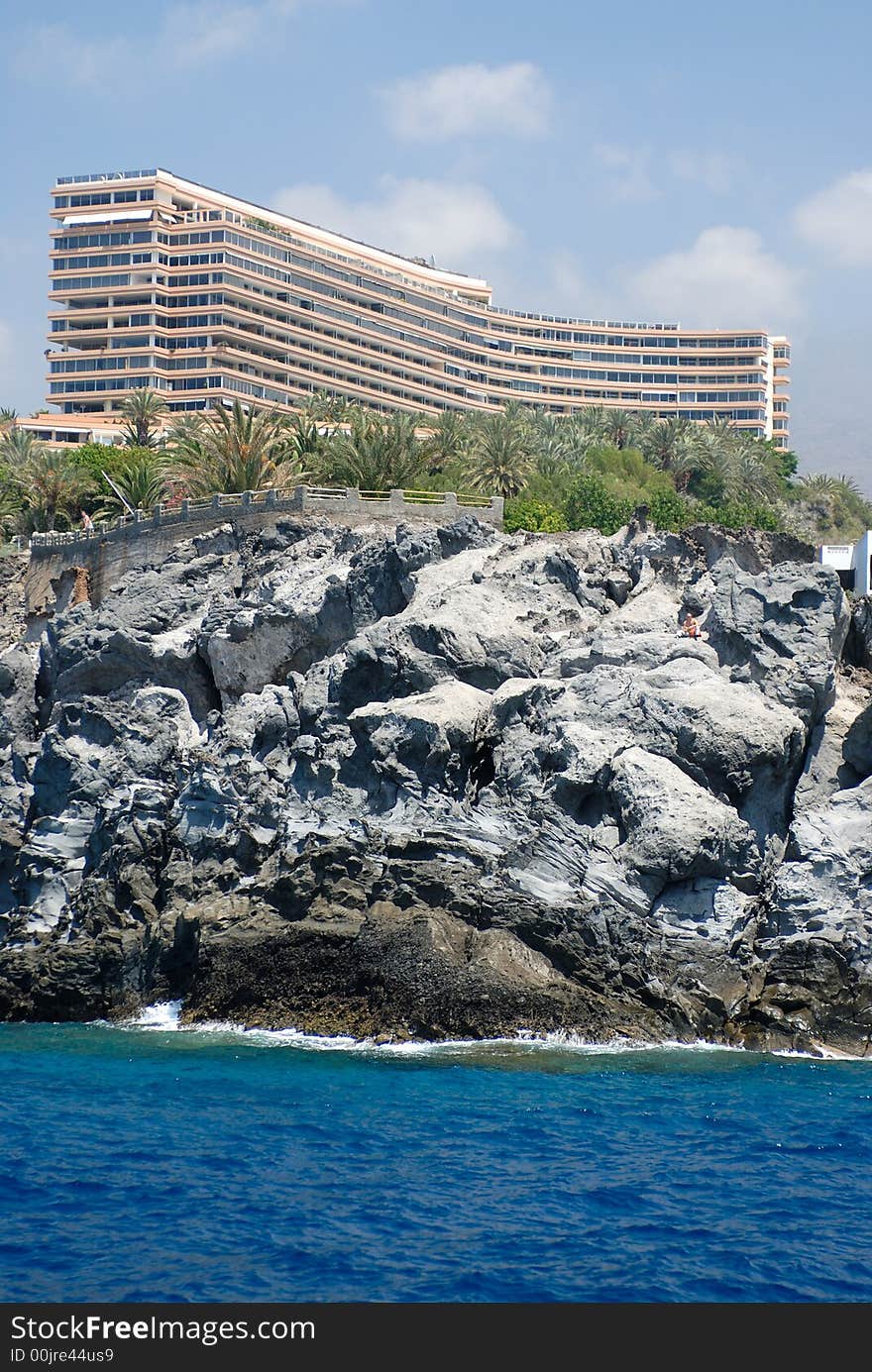 Hotel on the gray rock with the blue sky background. Hotel on the gray rock with the blue sky background