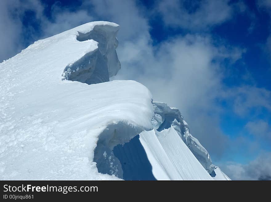 Detail of high mountain ridge over cloudy sky. Detail of high mountain ridge over cloudy sky