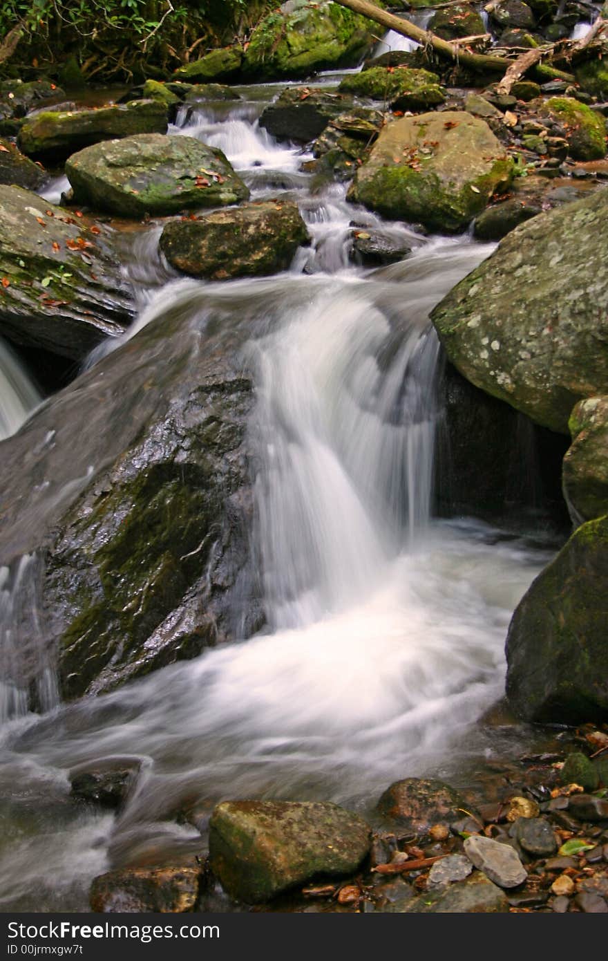 Water rushing over the moss covered rocks of a mountain stream in Helen, Georgia. Water rushing over the moss covered rocks of a mountain stream in Helen, Georgia