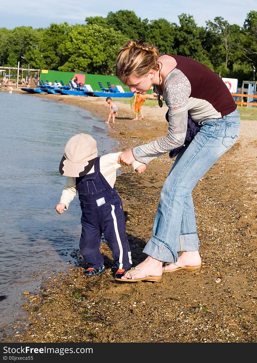 Mother With Child On The Coast