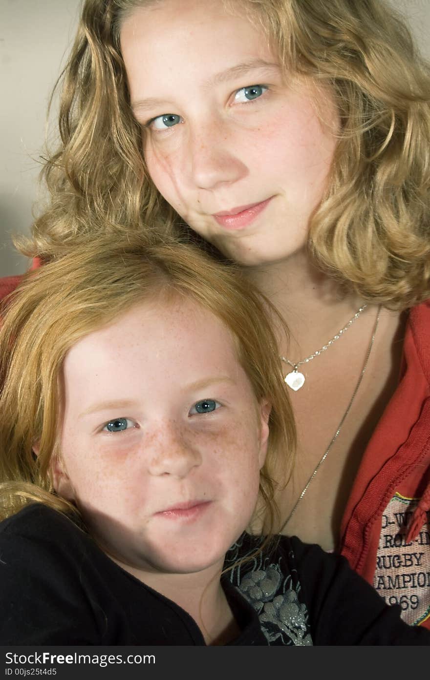 Two girls sitting together smiling