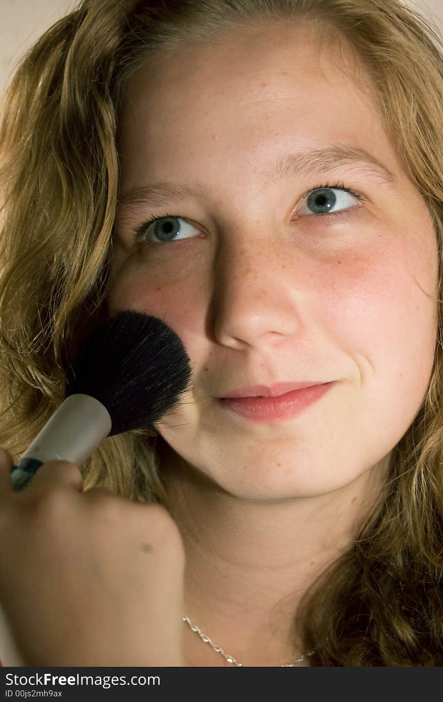 Young woman is being put powder on