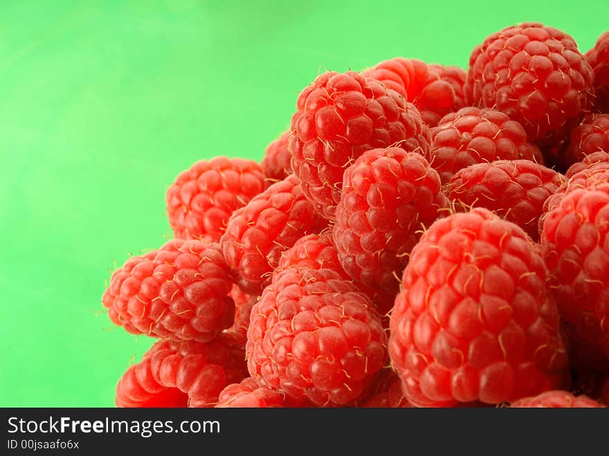 Red raspberry on  green background