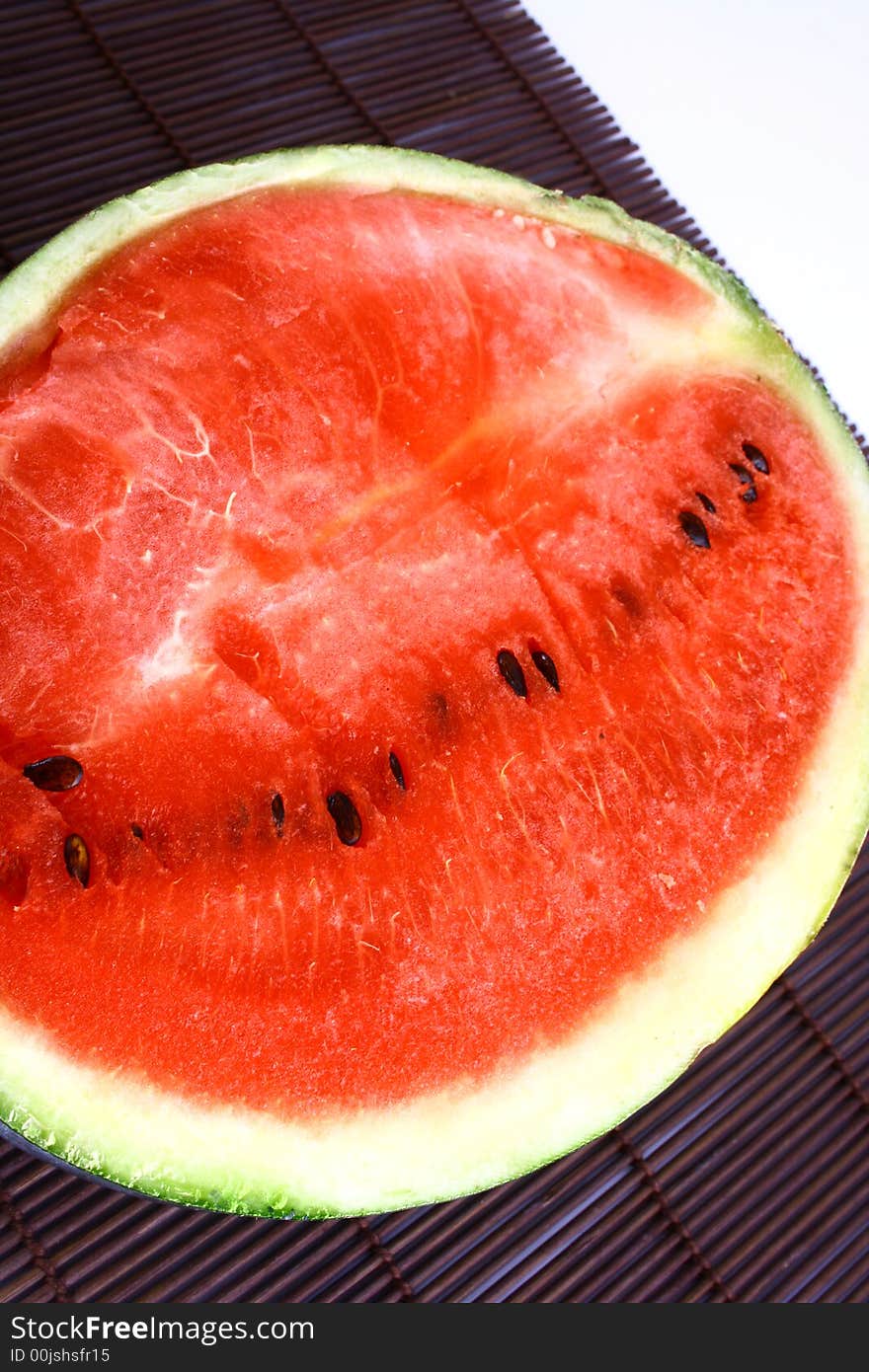 Background of brightly lit red watermelon slices.