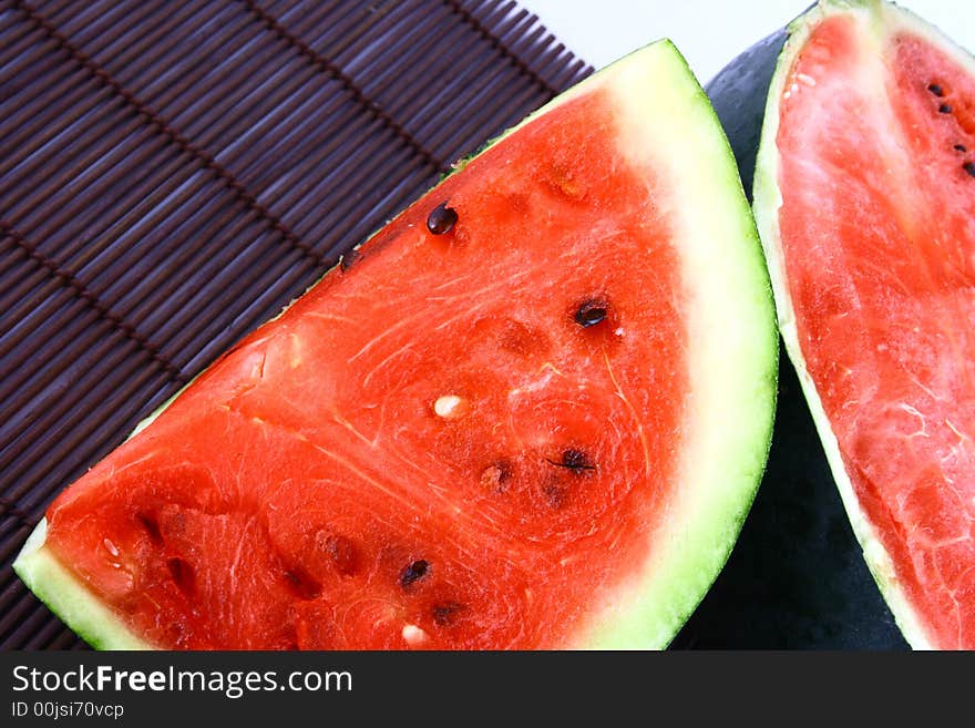 Background of brightly lit red watermelon slices.