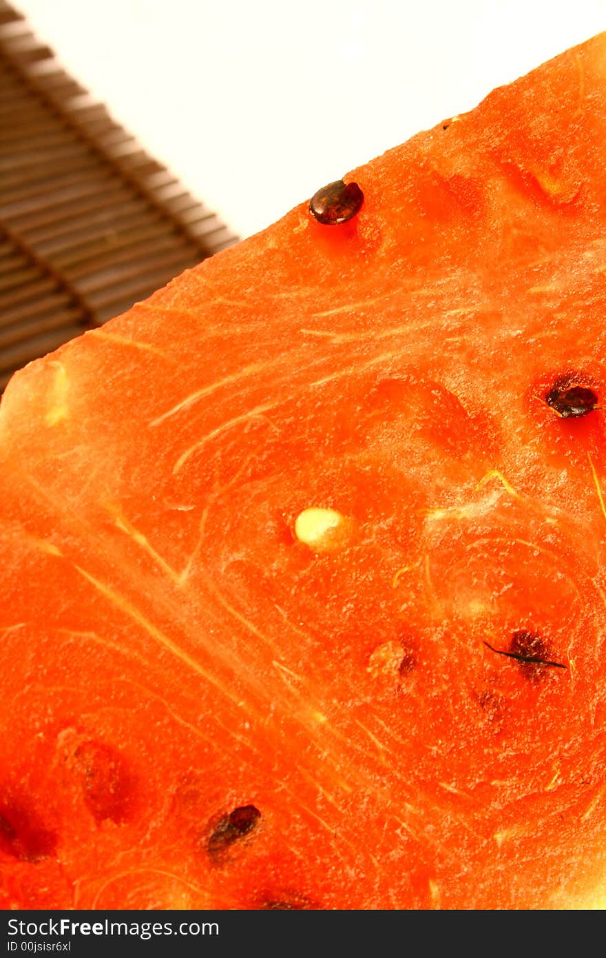 Background of brightly lit red watermelon slices.