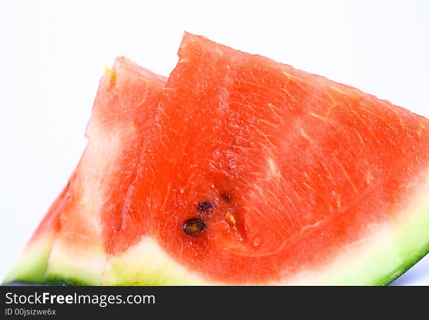 Background of brightly lit red watermelon slices.