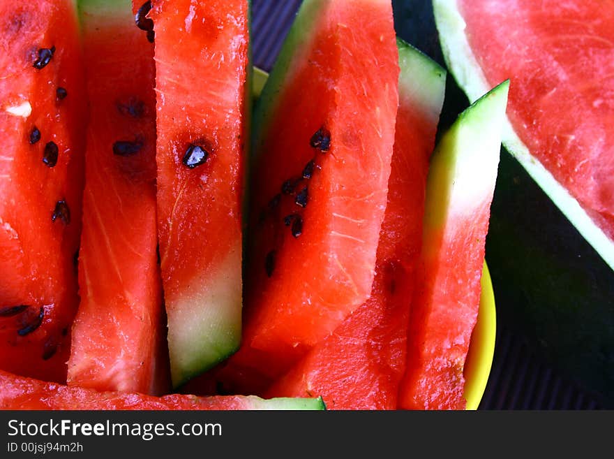 Background of brightly lit red watermelon slices.