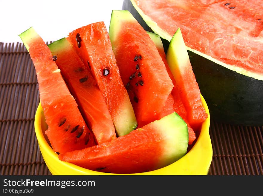 Background of brightly lit red watermelon slices.