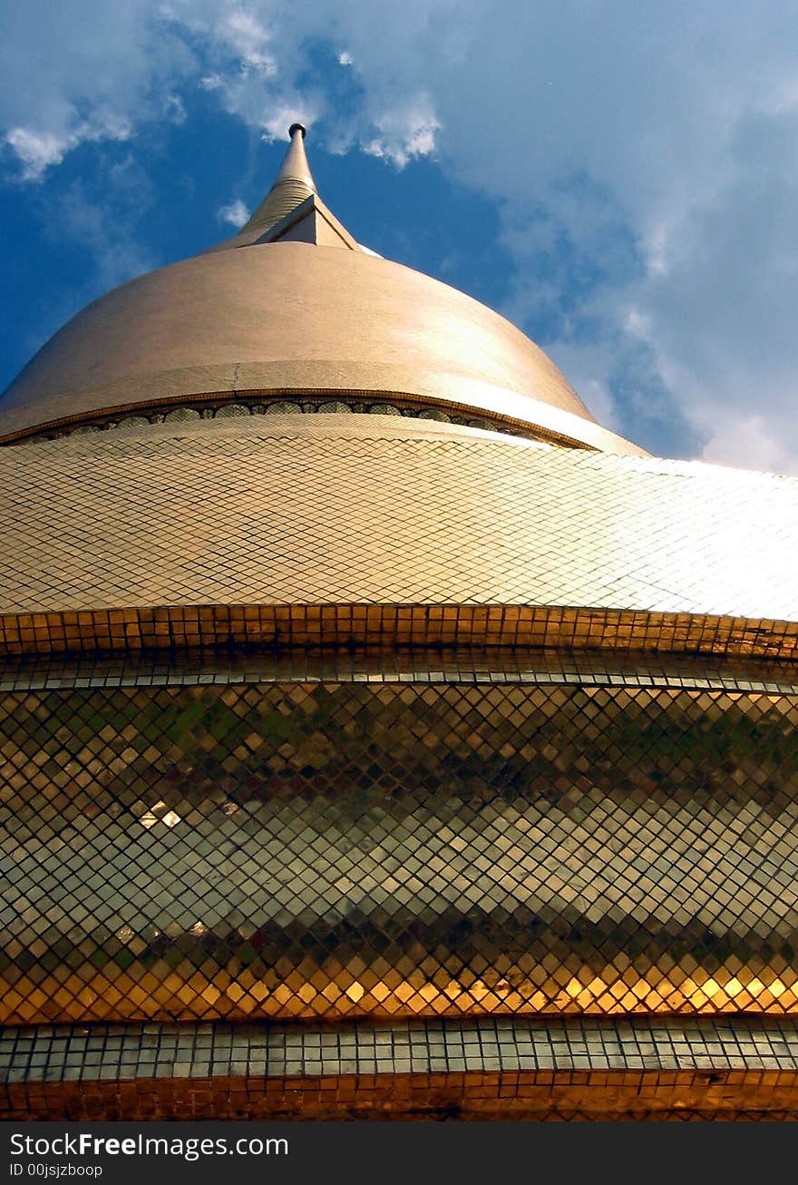 Top of a Thai Buddhist temple in the Grand Palace, Bangkok, Thailand, covered in gold leaf. Top of a Thai Buddhist temple in the Grand Palace, Bangkok, Thailand, covered in gold leaf.