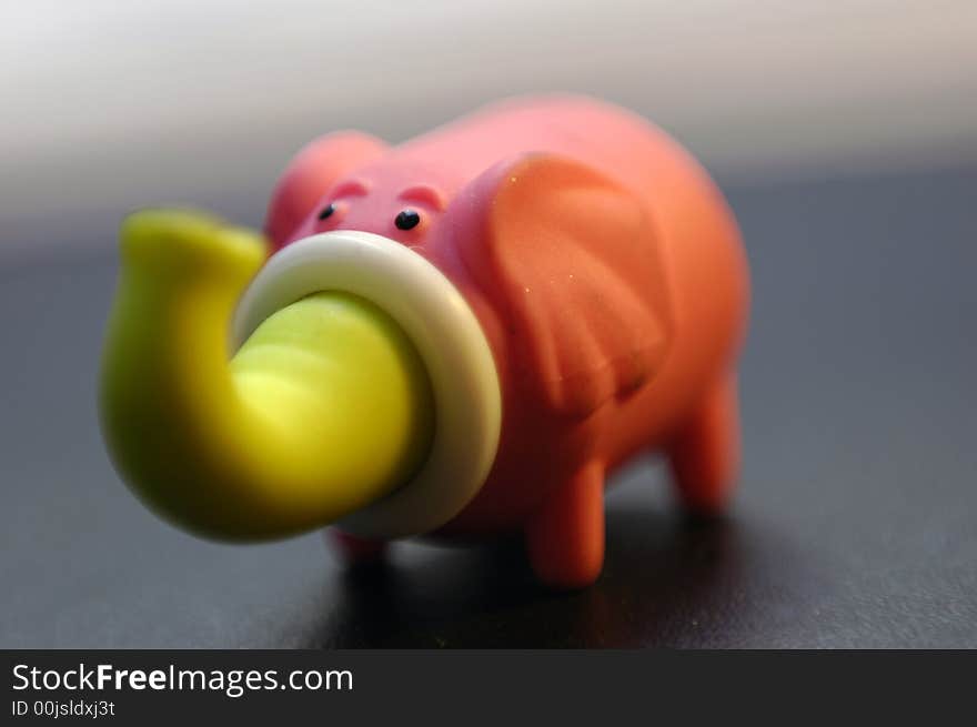 Rubber elephant isolated on a dark background