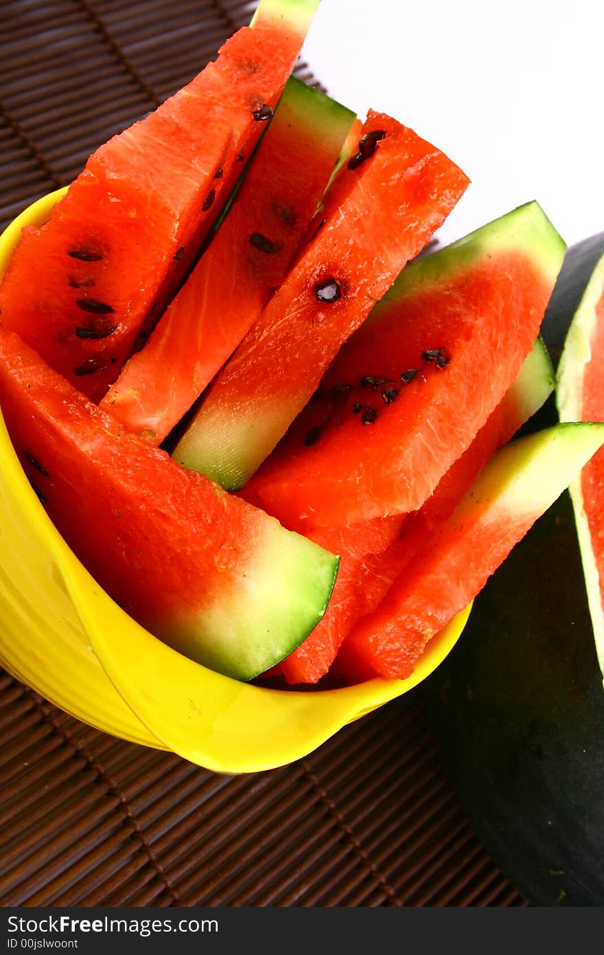 Background of brightly lit red watermelon slices.