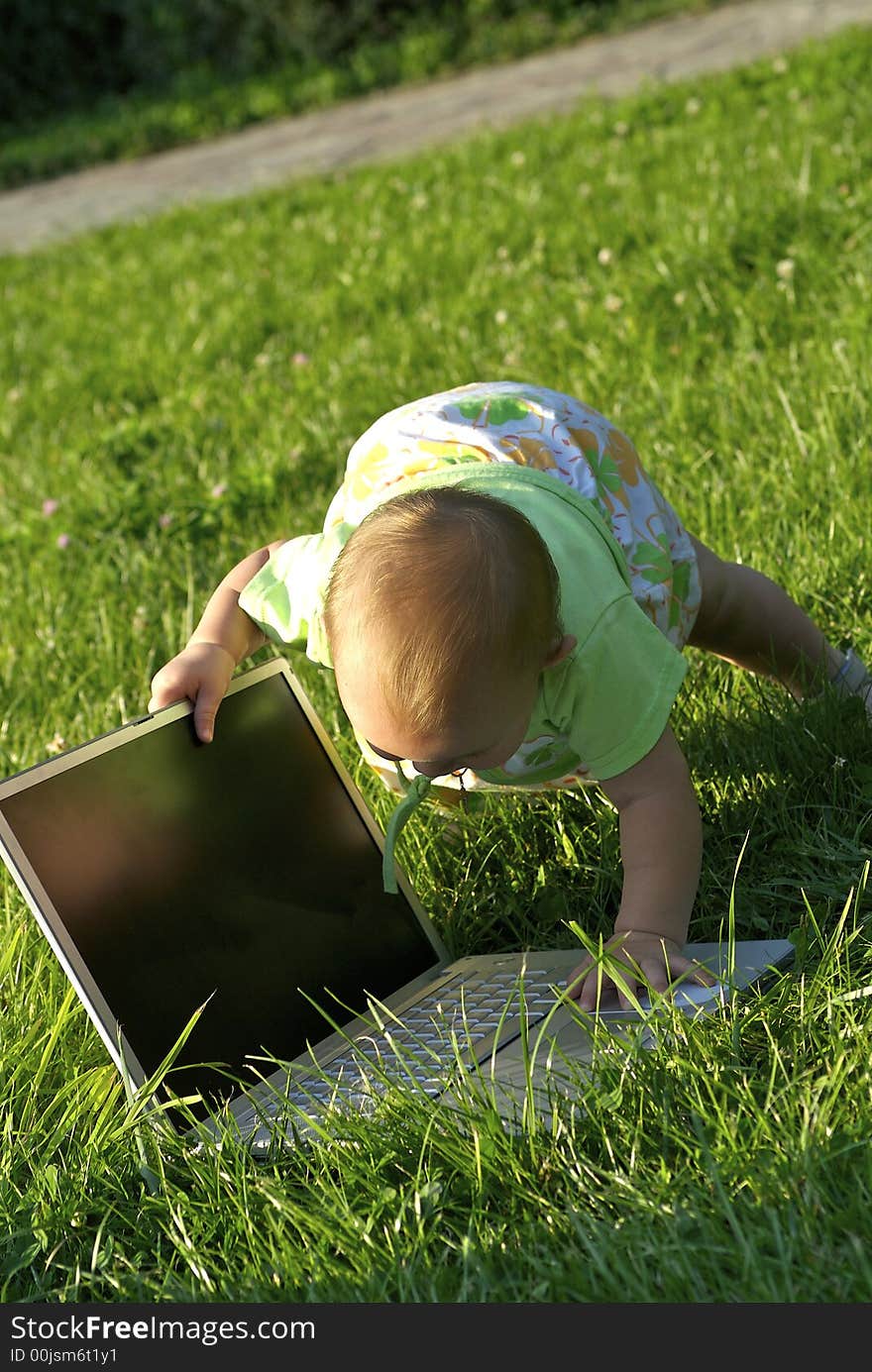 Girl with notebook on green meadow