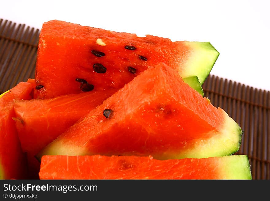 Background of brightly lit red watermelon slices.