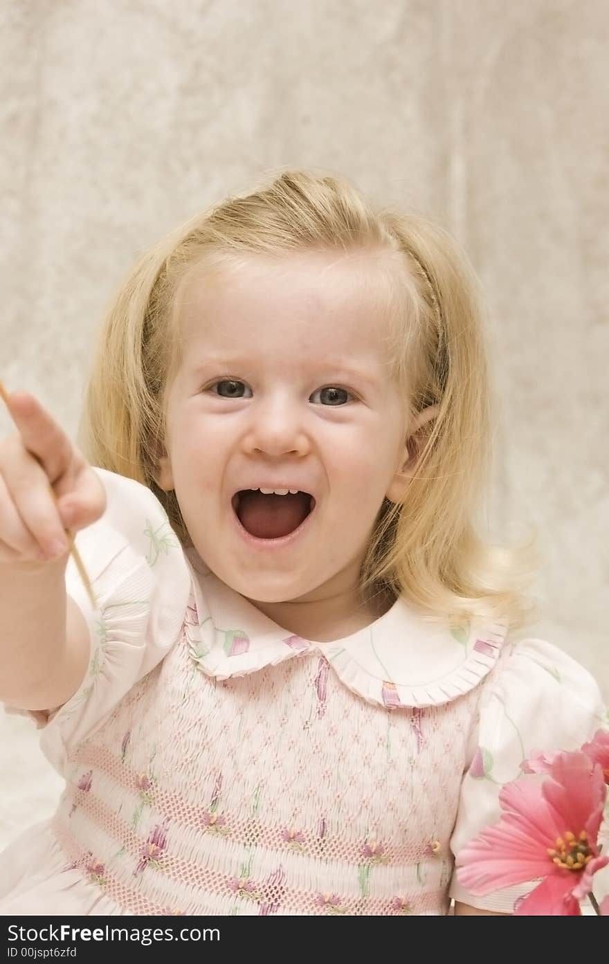 An excited beautiful girl pointing with laughter. An excited beautiful girl pointing with laughter