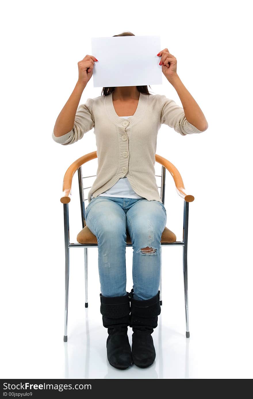 Sitting woman keeps sheet of paper before face