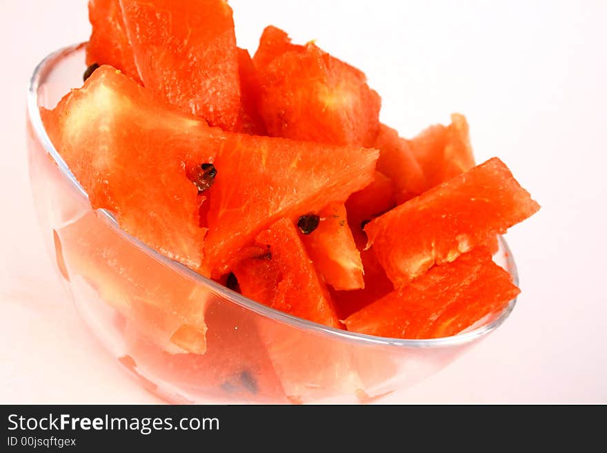 Background of brightly lit red watermelon slices.