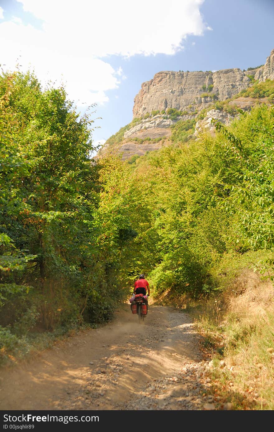 Biker on the mountain road. (Dimerdzhi mountain in Crimea, Ukraine)