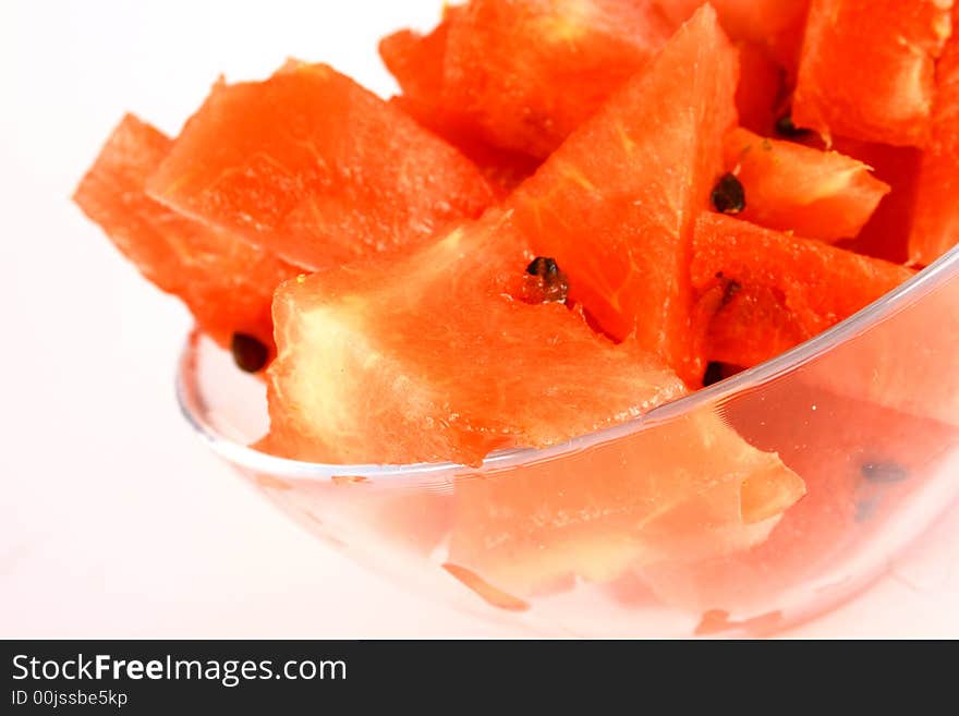 Background of brightly lit red watermelon slices.